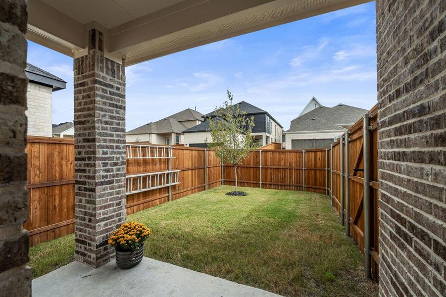 Fenced backyard with a patio and a residential view Fenced backyard with a patio and a residential view