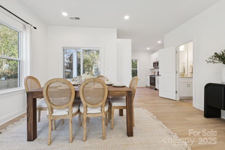 Living room flows seamlessly to the dining area, conveniently off the kitchen