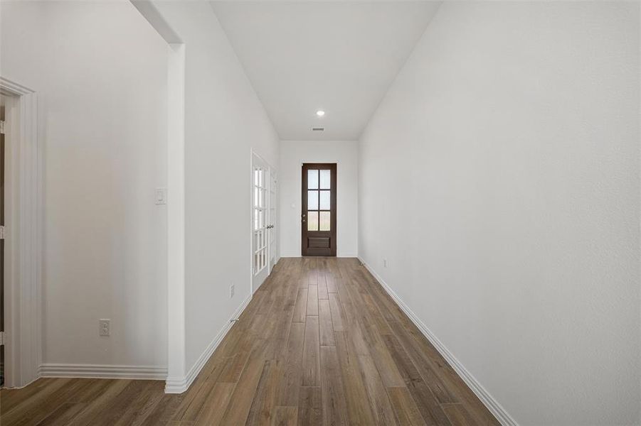 Entryway with wood finished floors and recessed lighting Entryway with wood finished floors and recessed lighting