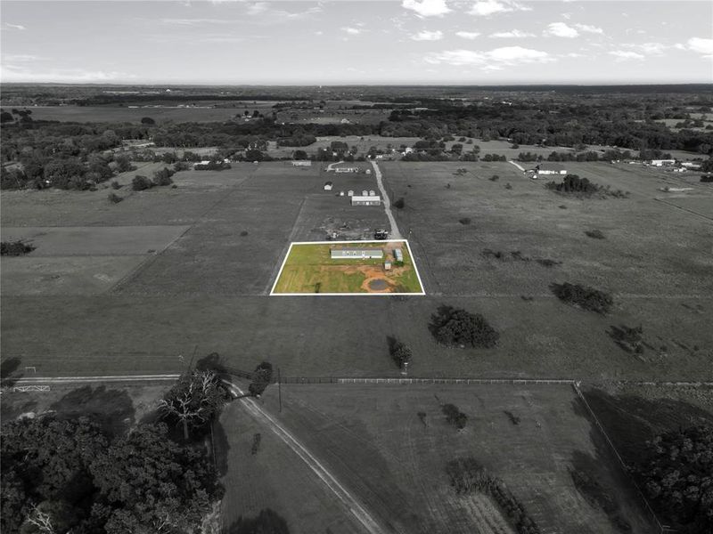 Aerial view of sparsely populated area with property parcel outlined Aerial view of sparsely populated area with property parcel outlined