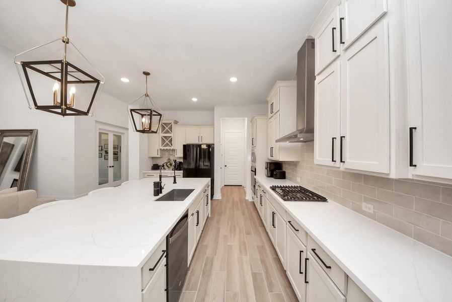 Spacious kitchen featuring quick garage access and a generous walk-in pantry for added convenience.