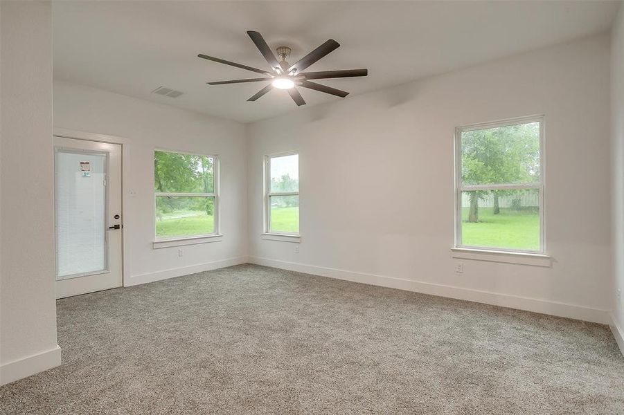 Unfurnished room featuring carpet floors and a ceiling fan