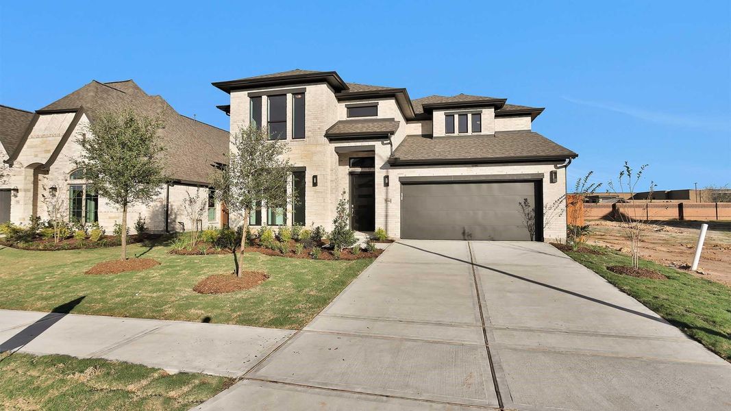 Front exterior of a new home in Elyson 55', Katy, TX, highlighting curb appeal (Image 2). Front exterior of a new home in Elyson 55', Katy, TX, highlighting curb appeal (Image 2).