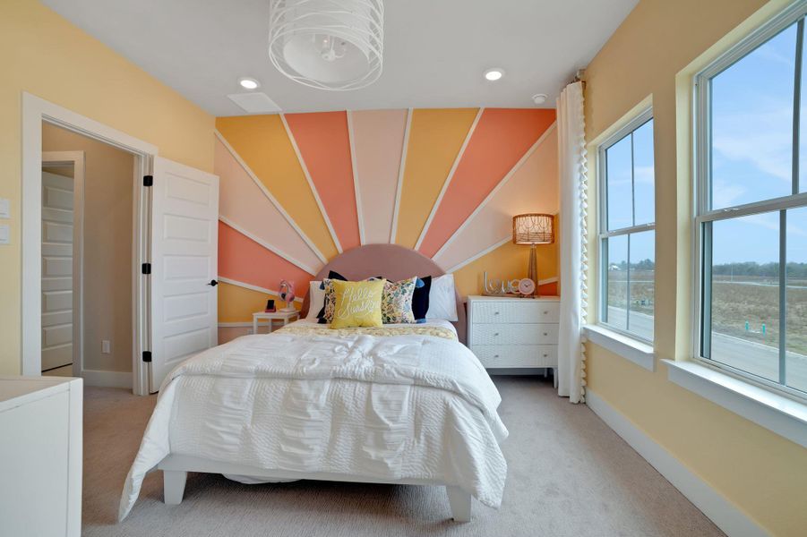 Bedroom with an accent wall, light colored carpet, and recessed lighting