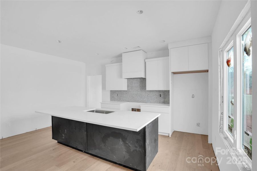 Large kitchen with two-tone soft close cabinetry and quartz countertops. Still a bit dusty as we are finishing up construction!