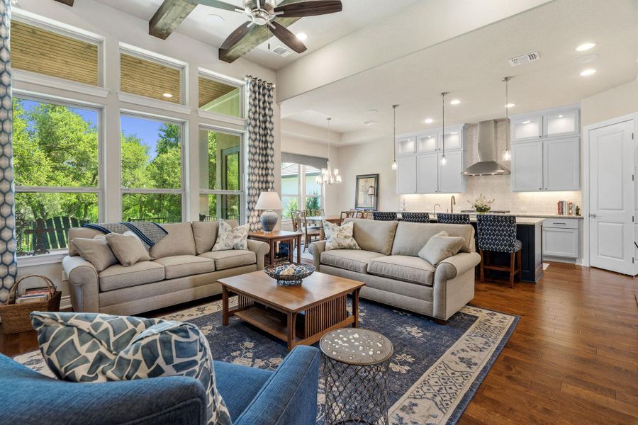 Soaring ceilings and oversized windows fill the living room with natural light and greenbelt views. Soaring ceilings and oversized windows fill the living room with natural light and greenbelt views.