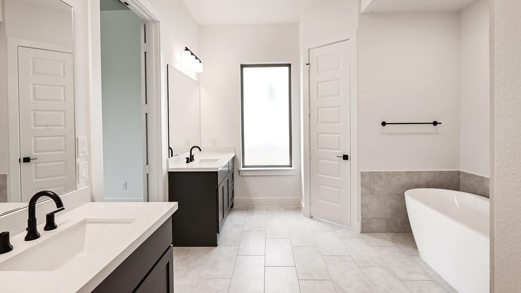Full bath with a freestanding bath and two vanities Full bath with a freestanding bath and two vanities