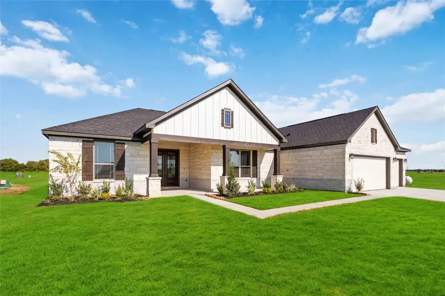 Front exterior of a new home in Blue Heron Estates, Beasley, TX, highlighting curb appeal (Image 1).