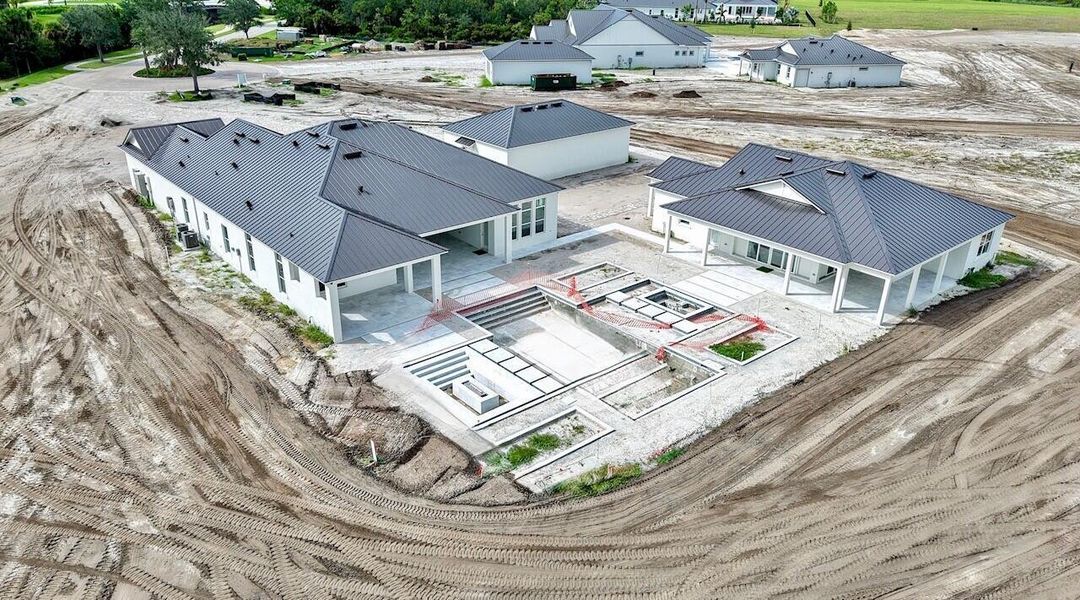 Front exterior of a new home in Bridgewater, Jupiter, FL, highlighting curb appeal (Image 1).