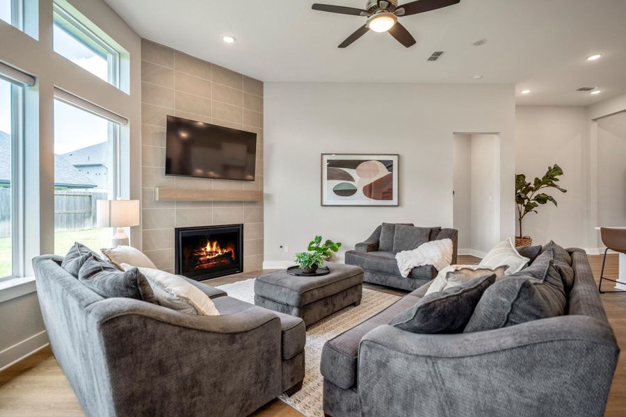 Gather around the gas-log fireplace and enjoy a family room designed for comfortable evenings, easy conversation and everyday moments, all brightened by stacked windows overlooking the backyard.