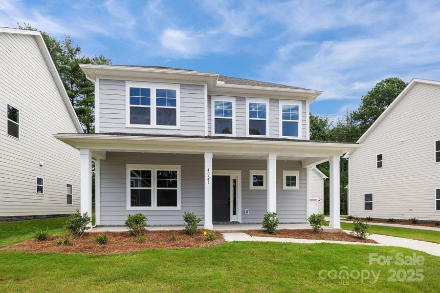 Oversized covered porch. 2 car rear detached garage