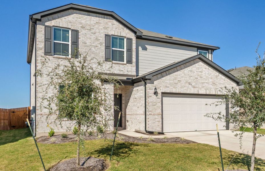 Front exterior of a new home in Lagos, Manor, TX, highlighting curb appeal (Image 17). Front exterior of a new home in Lagos, Manor, TX, highlighting curb appeal (Image 17).
