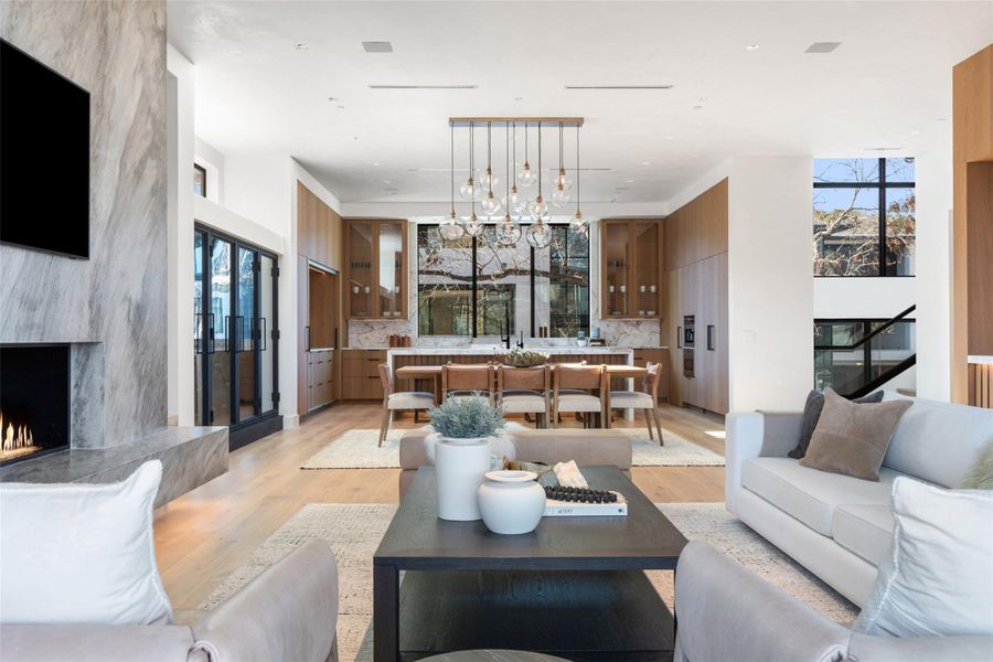 Living room with a premium fireplace and light wood-style floors