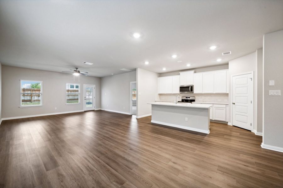 Dining room, living room, and kitchen in the Reynolds floorplan at a Meritage Homes community.