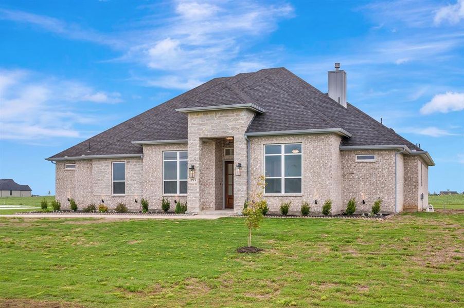 View of front of house with a front lawn, stone siding, roof with shingles, a chimney, and brick siding View of front of house with a front lawn, stone siding, roof with shingles, a chimney, and brick siding