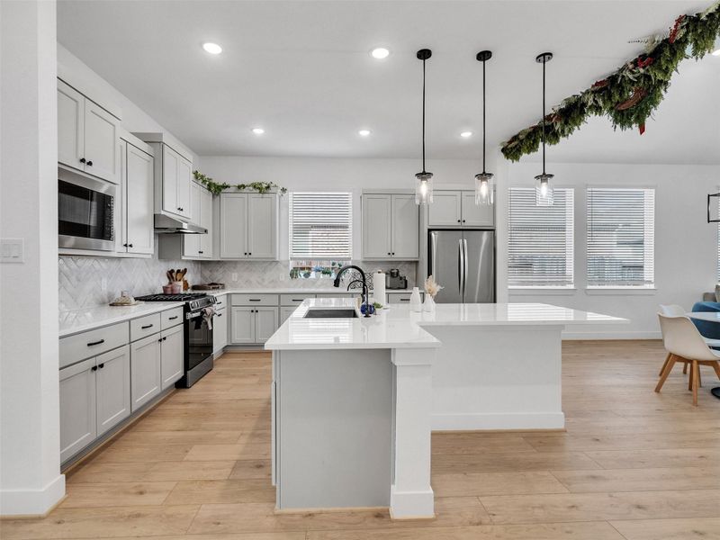 Kitchen has lots of counterspace and cabinets with a great breakfast bar.