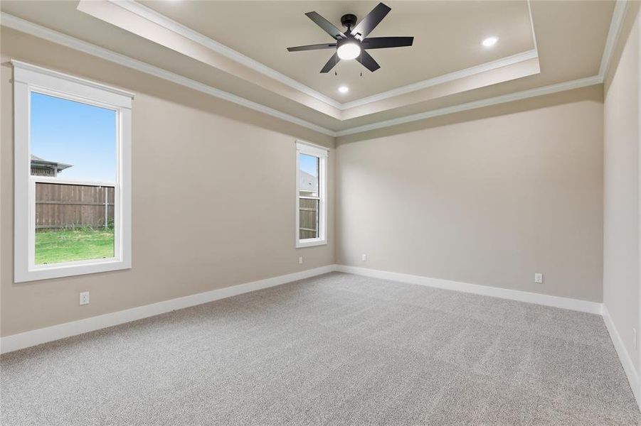 Spacious room featuring light gray carpeting and neutral wall tones Spacious room featuring light gray carpeting and neutral wall tones