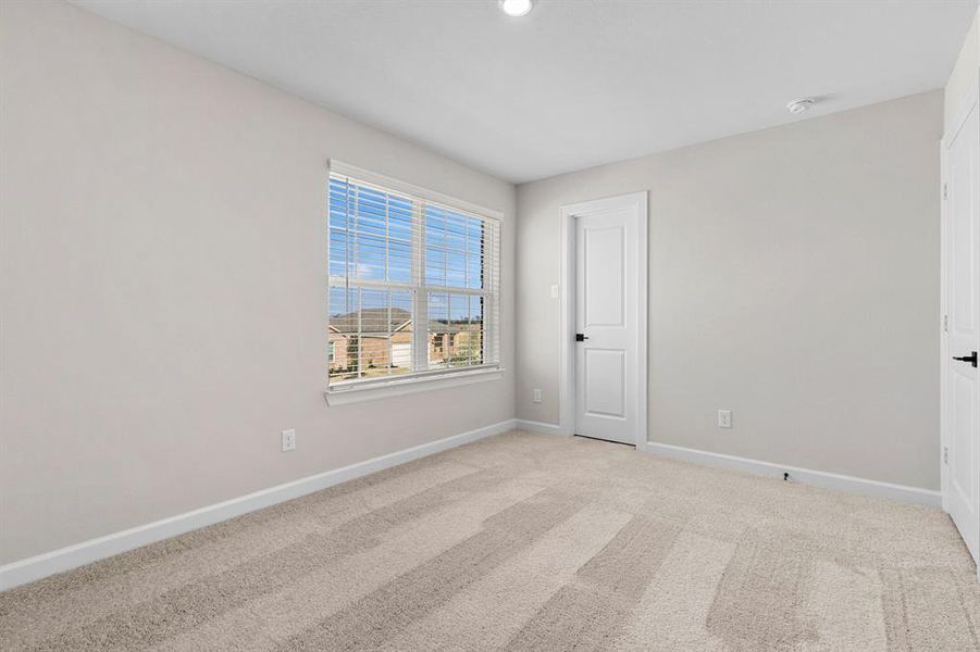 One of the three generously sized upstairs bedrooms.