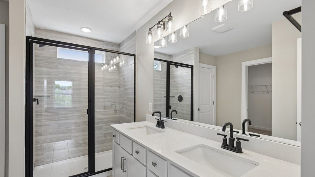 Bathroom with tile shower and glass enclosure, along with dual vanity Bathroom with tile shower and glass enclosure, along with dual vanity