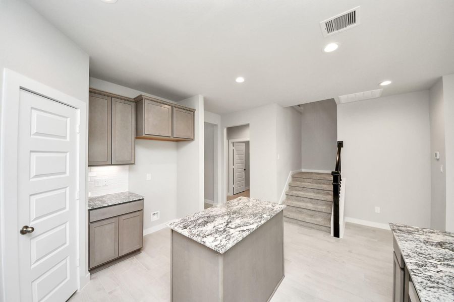 The extended counter area adds both practicality and style, making meal preparation a breeze. Every detail is thoughtfully designed to enhance the kitchen's functionality and aesthetic appeal. Sample photo of completed home with similar floor plan. Actual colors and selections may vary. The extended counter area adds both practicality and style, making meal preparation a breeze. Every detail is thoughtfully designed to enhance the kitchen's functionality and aesthetic appeal. Sample photo of completed home with similar floor plan. Actual colors and selections may vary.