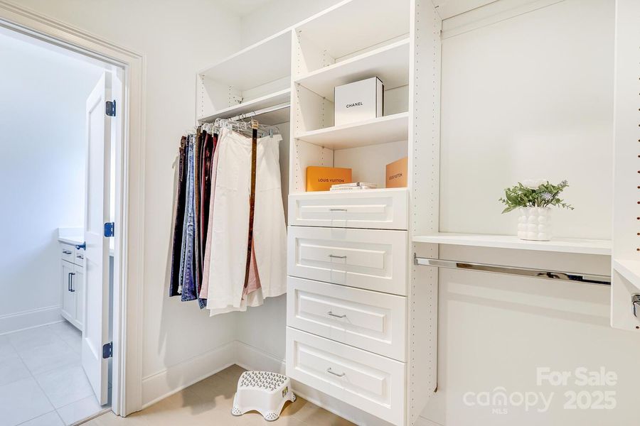 Large primary closet connects to laundry room