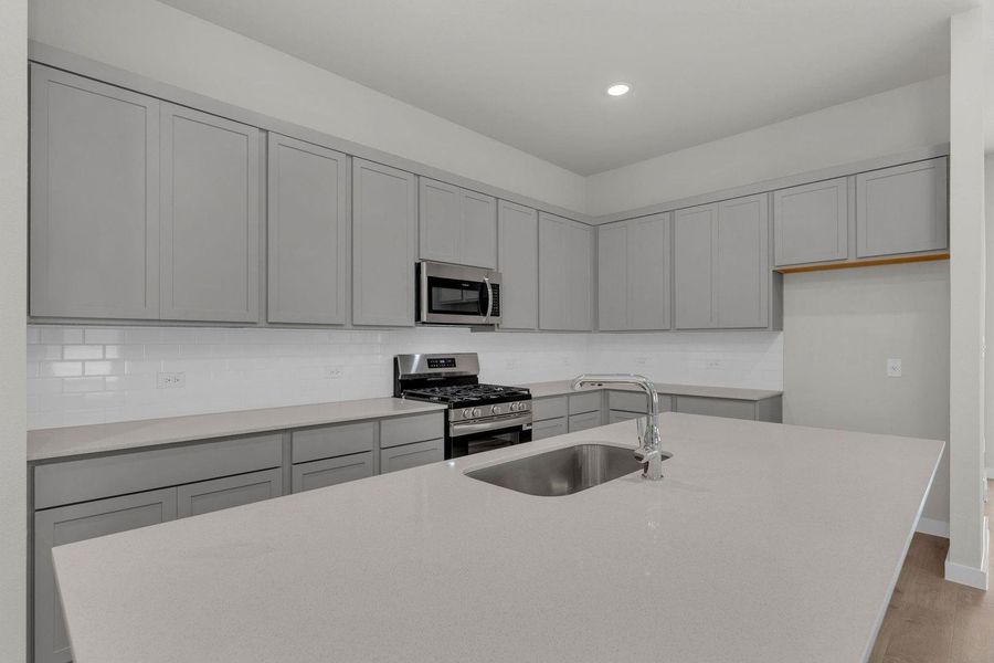 Kitchen in the Pecos home plan by Trophy Signature Homes – REPRESENTATIVE PHOTO