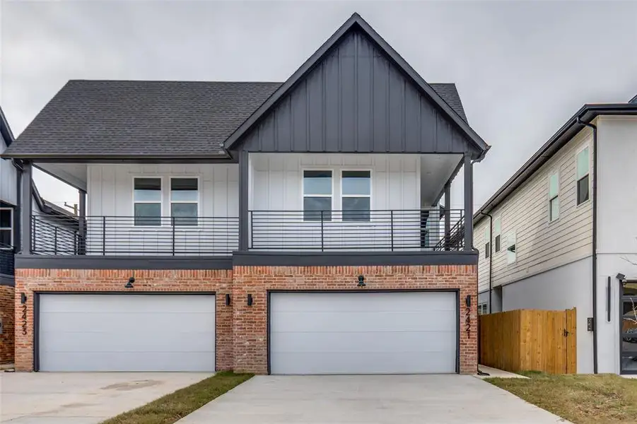 Example of similar build - View of front of property with driveway, a balcony, board and batten siding, and an attached garage Example of similar build - View of front of property with driveway, a balcony, board and batten siding, and an attached garage
