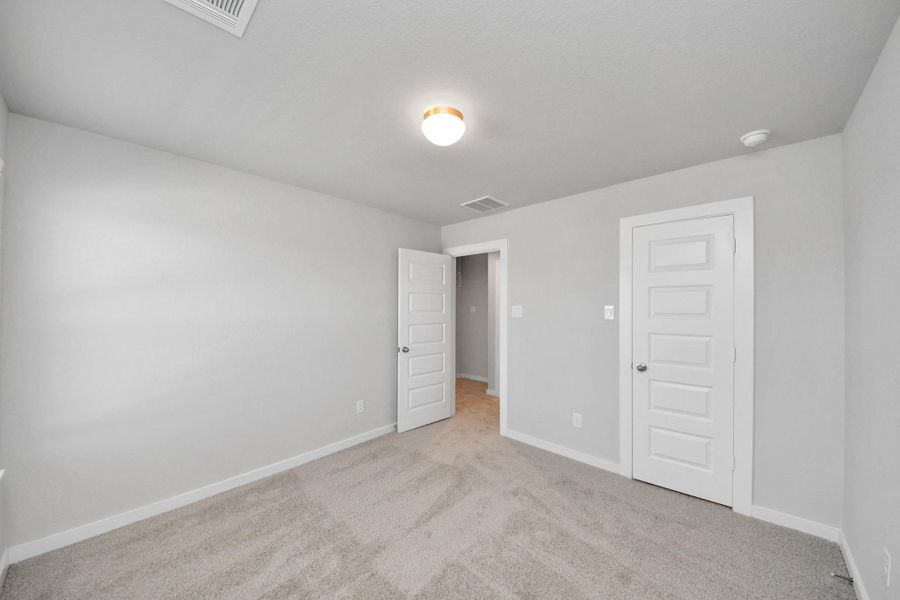 Generously sized secondary bedrooms featuring spacious closets, soft and inviting carpeting underfoot, large windows allowing plenty of natural light, and the added touch of privacy blinds for your personal retreat. Sample photo of completed home with similar floor plan. Actual colors and selections may vary. Generously sized secondary bedrooms featuring spacious closets, soft and inviting carpeting underfoot, large windows allowing plenty of natural light, and the added touch of privacy blinds for your personal retreat. Sample photo of completed home with similar floor plan. Actual colors and selections may vary.