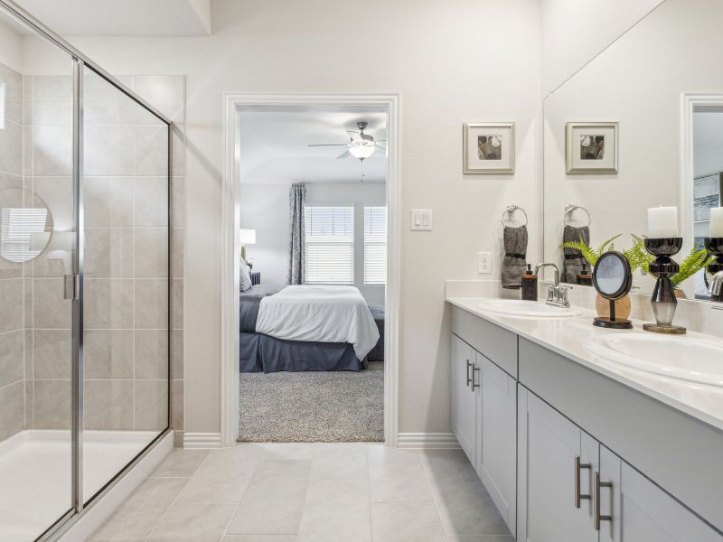 Primary bathroom with double vanity and large walk-in closet