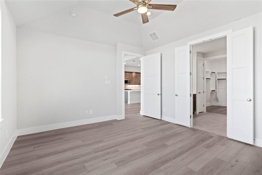 Additional view from the primary bedroom looking towards the ensuite primary bathroom and the double door entrance!
