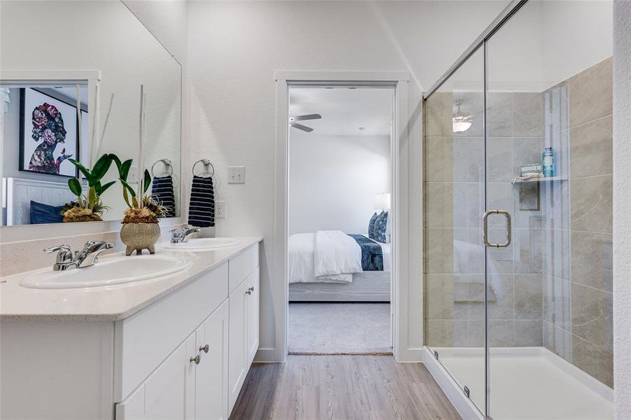 Bathroom featuring an enclosed shower, ceiling fan, hardwood / wood-style floors, and vanity