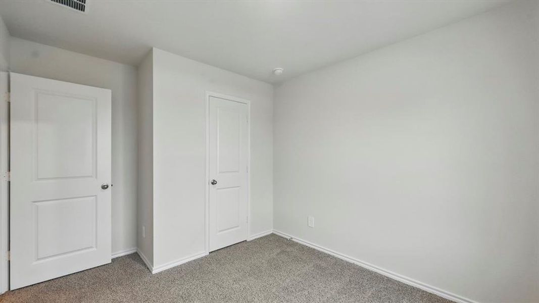 Unfurnished bedroom with baseboards and carpet floors
