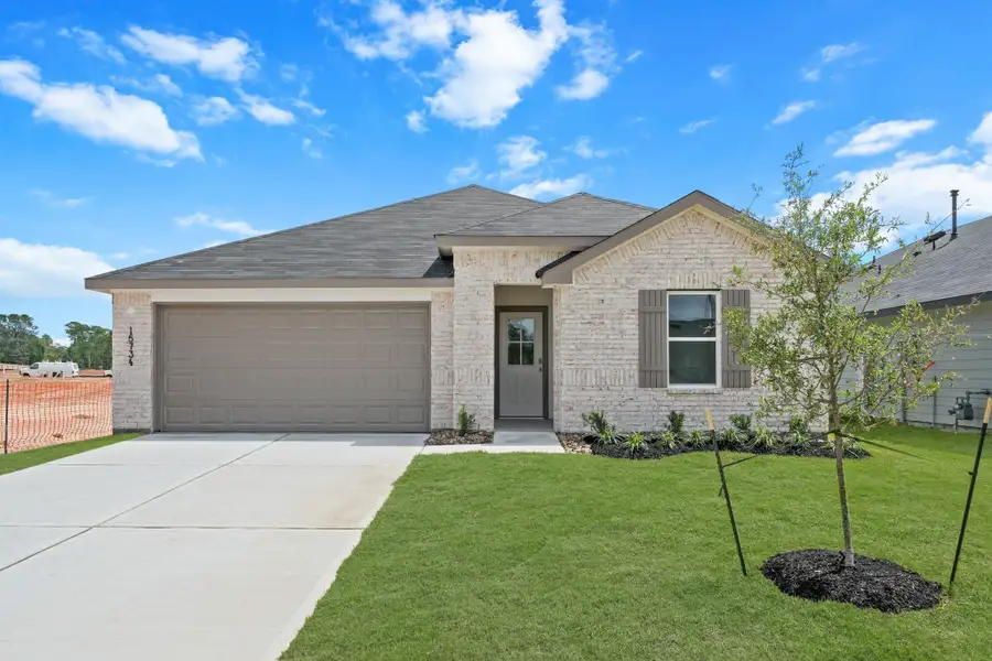 Front exterior of a new home in Chapel Lakes, Montgomery, TX, highlighting curb appeal (Image 1). Front exterior of a new home in Chapel Lakes, Montgomery, TX, highlighting curb appeal (Image 1).