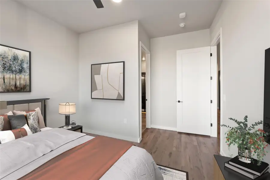 Bedroom featuring wood finished floors, baseboards, and ceiling fan