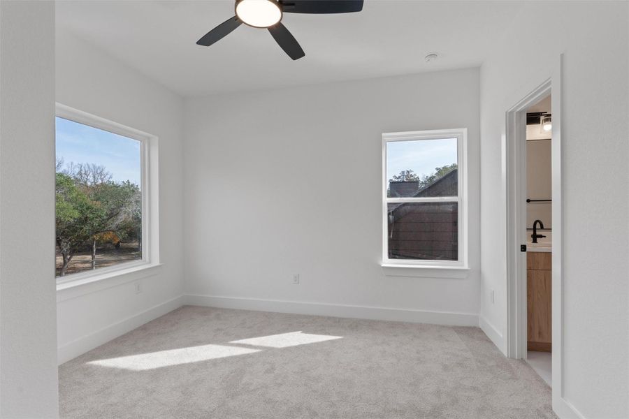 Bedroom #2 with plush carpet and plenty of natural light. This room has it's on en suite bath. Bedroom #2 with plush carpet and plenty of natural light. This room has it's on en suite bath.
