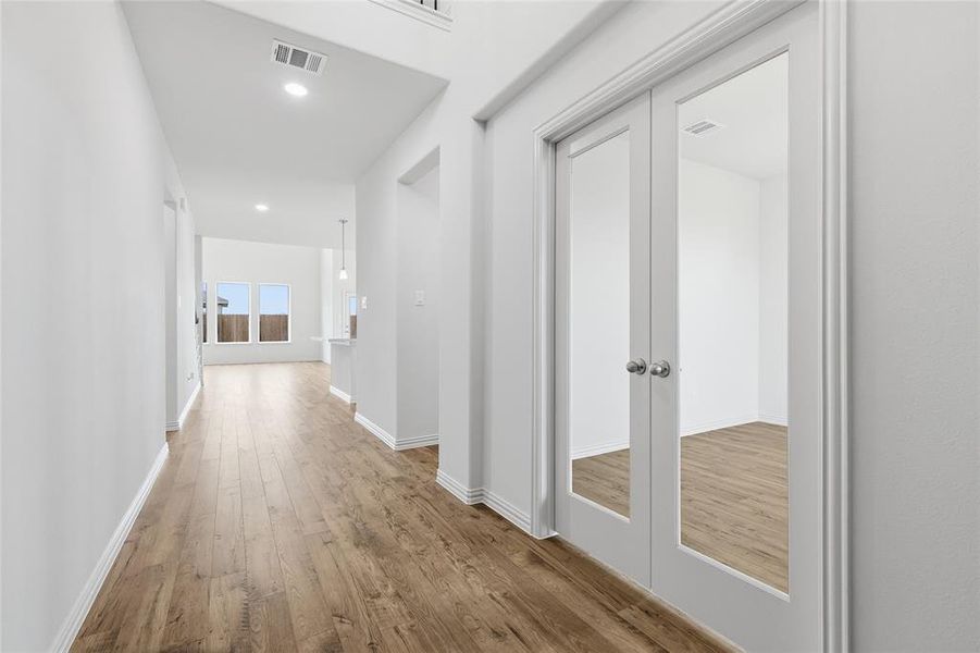 Entryway featuring wood-finish flooring, white baseboards, and a neutral wall palette