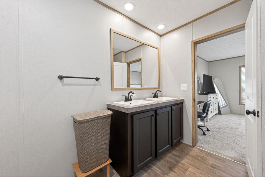 Large primary bathroom featuring a double vanity and modern finishes, designed for both comfort and functionality Large primary bathroom featuring a double vanity and modern finishes, designed for both comfort and functionality