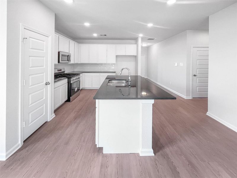 The Waring III- Kitchen with Large Island. Sample image for illustration; upgrades, options, and colors may vary.