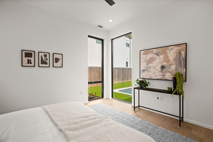 Bedroom with light wood finished floors, ceiling fan, recessed lighting, and access to exterior