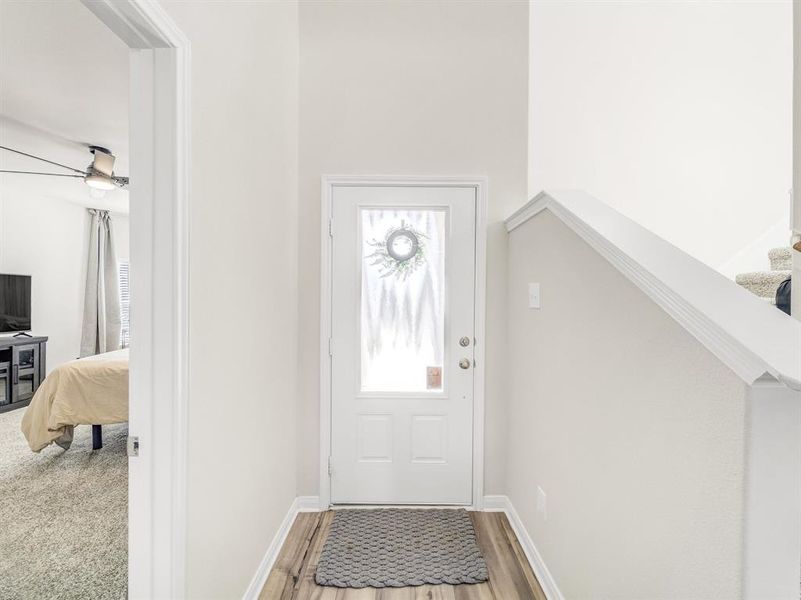 Entryway with light wood finished floors and stairs
