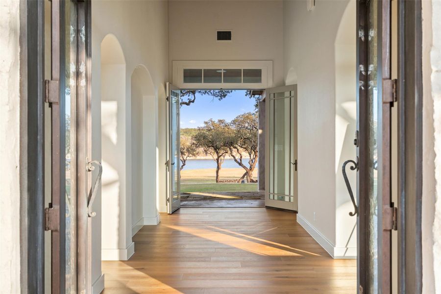 Foyer entrance at Arcadia featuring light wood-type flooring and a water view
