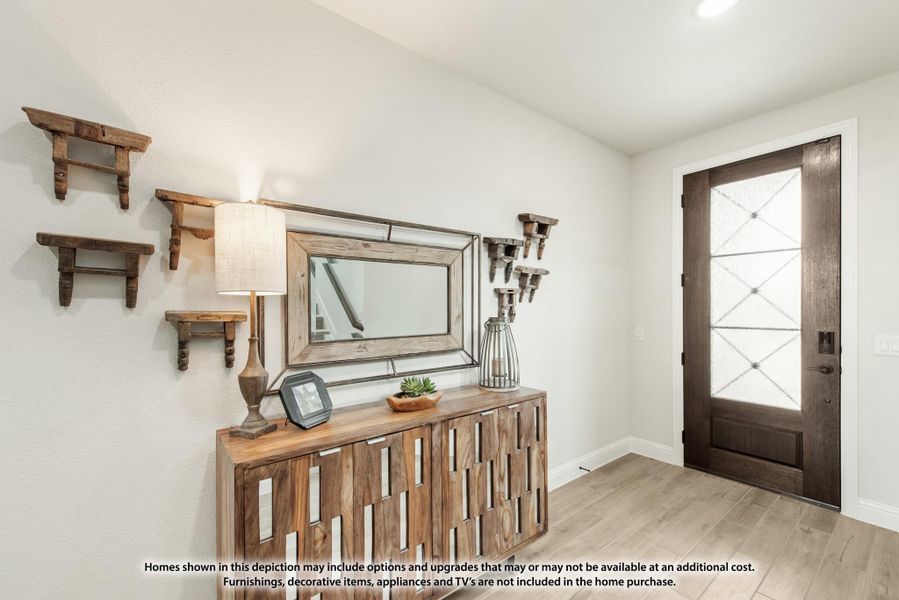 Entryway with dark wood front door, wood console table, wall mirror, and decorative shelves on light gray walls