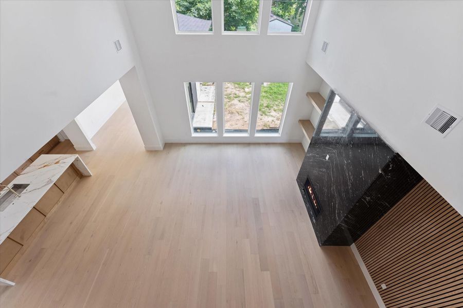 Experience an expansive view of the elegant family room from the second floor overlook, highlighting its open layout and natural light. Experience an expansive view of the elegant family room from the second floor overlook, highlighting its open layout and natural light.