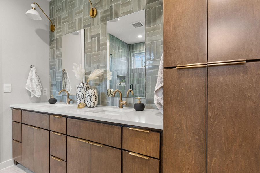 Full bath featuring double vanity, a sink, and visible vents