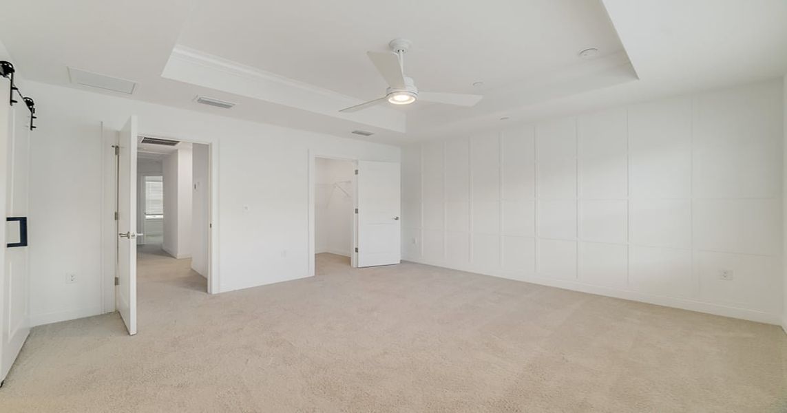 Primary suite with decorated feature wall & tray ceiling Primary suite with decorated feature wall & tray ceiling
