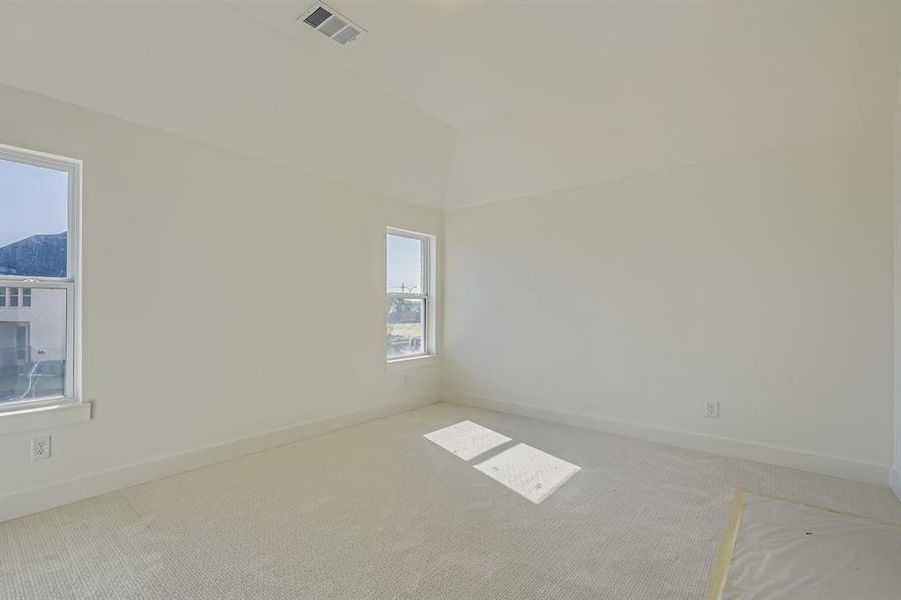 Carpeted empty room featuring baseboards Carpeted empty room featuring baseboards
