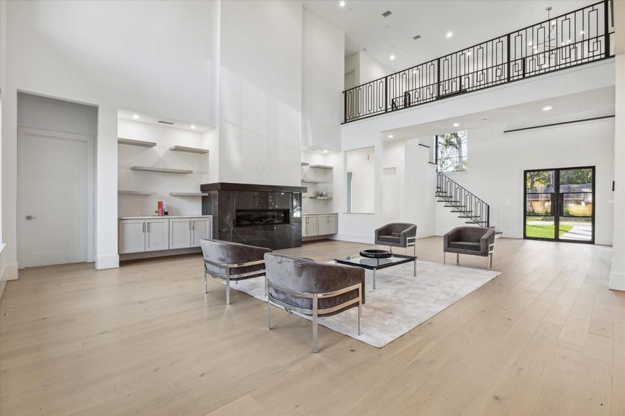 2 story Family Room with Pietra Grey Italian Marble surrounding fireplace 2 story Family Room with Pietra Grey Italian Marble surrounding fireplace