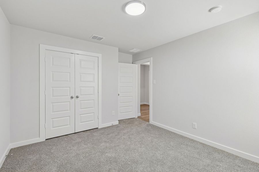 Bedroom in the Harrison home plan by Trophy Signature Homes – REPRESENTATIVE PHOTO