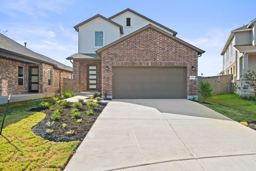 Front exterior of a new home in Flora, Hutto, TX, highlighting curb appeal (Image 1).