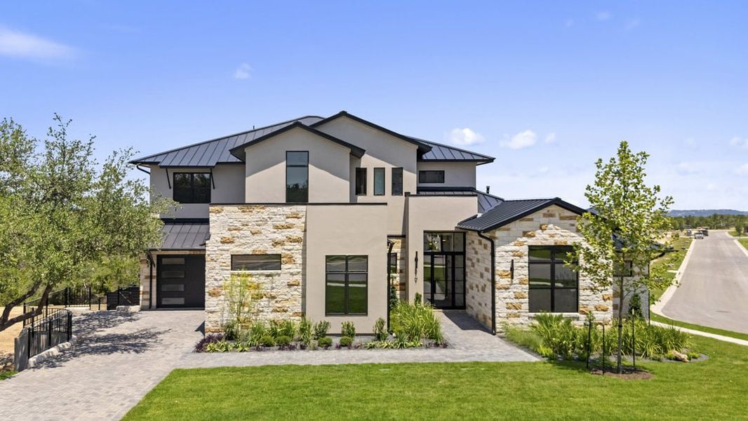 Front exterior of a new home in Milky Way at River Place, Austin, TX, highlighting curb appeal (Image 1). Front exterior of a new home in Milky Way at River Place, Austin, TX, highlighting curb appeal (Image 1).